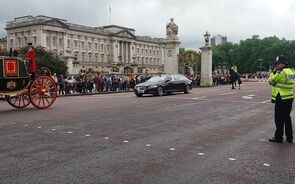 Carro da rainha Isabel II aplaudido junto ao Palácio de Buckingham