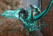 Uma rapariga reage quando lhe é atirada água colorida para a cara, no Festival das Cores, em Mumbai, na Índia.