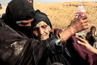 Mulheres iraquianas fogem para o deserto devido aos combates entre as forças iraquianas e o Estado Islâmico em Mossul.