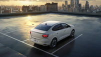Dacia Logan estacionado num telhado com vista para a cidade ao pôr do sol