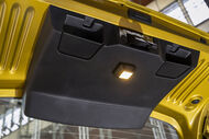 Detalhe da luz interior e compartimentos de um porta-bagagens amarelo